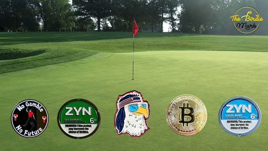 Custom golf ball markers from The Birdie Mark displayed on putting green next to a putter and golf ball